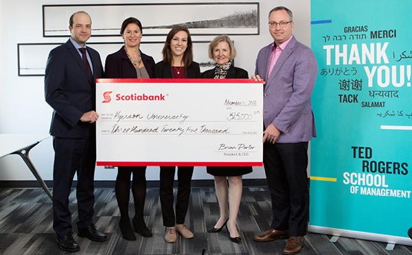 A group of people holding a Scotiabank cheque