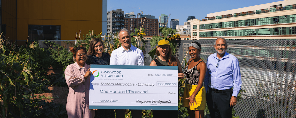 Graywood Developments presenting a cheque for $100,000 to the Urban Farm at one of the rooftop farms.
